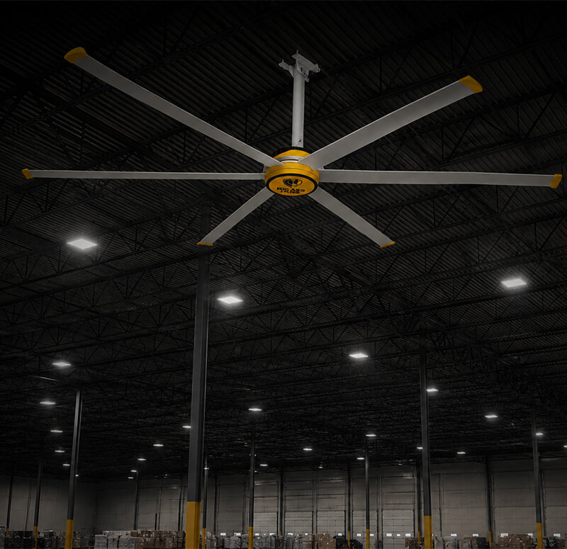 Large Big Ass Fans® HVLS ceiling fan installed inside an industrial warehouse with high ceilings and LED lighting to improve airflow and employee comfort.